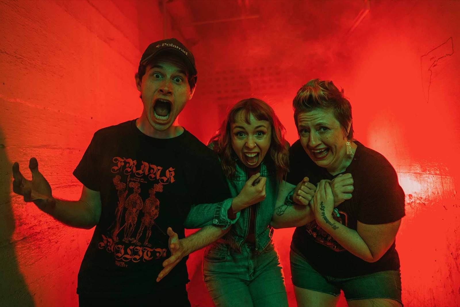 Guests recoiling in a red-lit corridor at Dark Prison